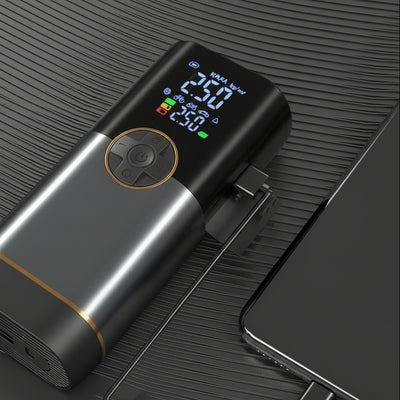 Black electronic device with digital display and USB cable on a dark surface At Aezoon