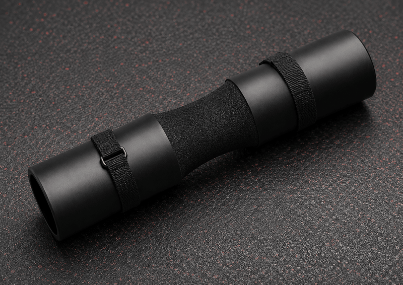 Black rolled-up mat on a textured dark surface