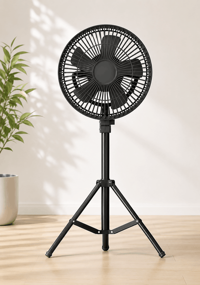 Black stand fan on a wooden floor with a light background