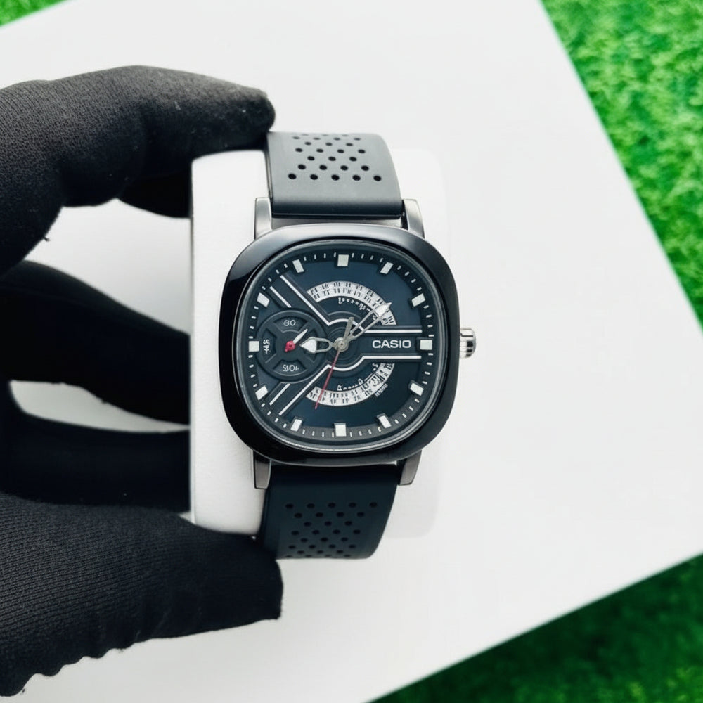 Black wristwatch with a white strap on a green and white background At Aezoon