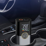 Car air compressor in a car cup holder with digital display and Chinese text on a dark background. At Aezoon