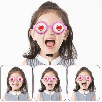 Child wearing funny heart eye novelty party glasses