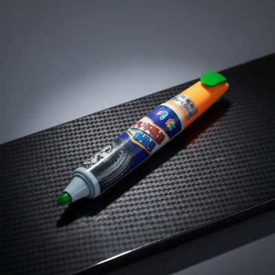 Colorful marker on a textured black surface at Aezoon