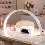 Gel nail lamp on a marble counter with decorative items in a salon setting