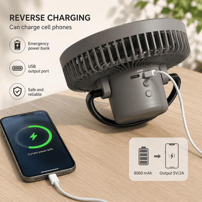 Gray power bank with USB cable charging a smartphone on a wooden surface.