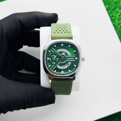 Green wristwatch with a white strap on a white background At Aezoon