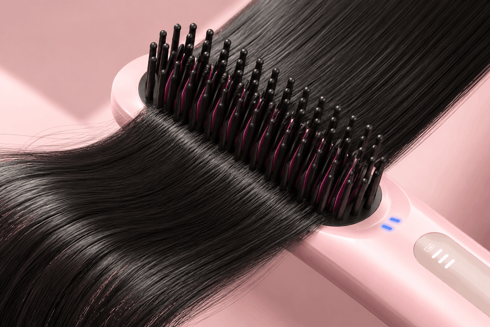 Hair straightening brush with long black hair on a pink background