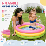Happy toddler splashing water in a 3-ring blow-up pool with mother watching