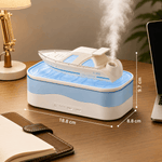 Humidifier with steam release on a desk next to a laptop and lamp.