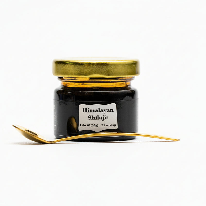 Jar of Himalayan Shilajit with a gold spoon on a white background At Aezoon