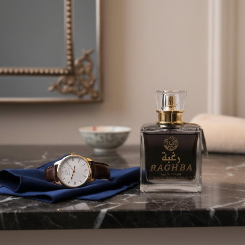 Perfume bottle labeled 'Ragha' on a marble surface with a watch and decorative items. At Aezoon