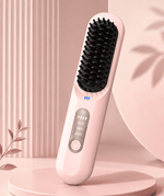 Pink hairbrush with black bristle head on a pink background