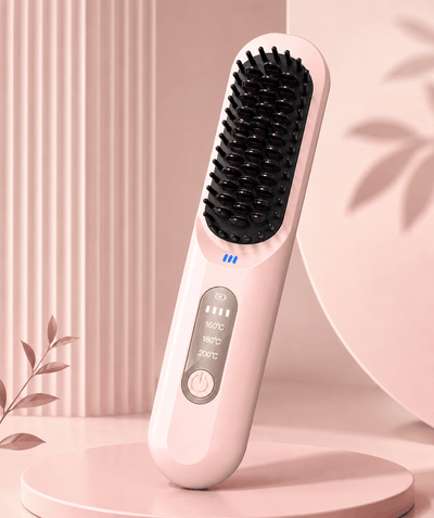 Pink hairbrush with black bristle head on a pink background
