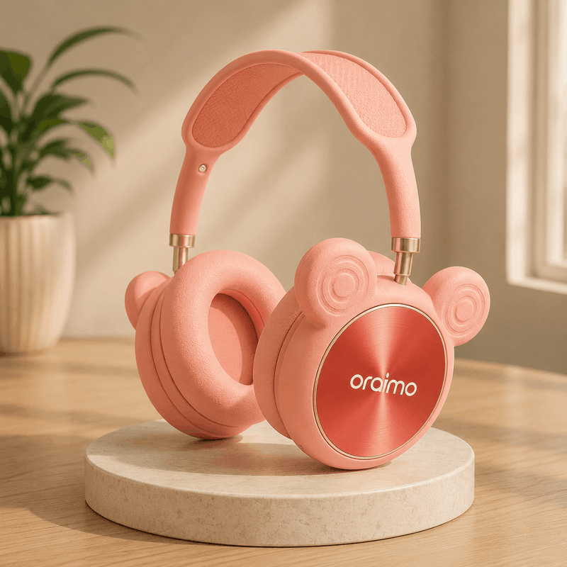 Pink headphones with 'oraimo' branding on a wooden surface with a plant in the background