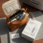 Portable oral hygiene kit with brown case, toothbrush, and packaging on a wooden surface. At Aezoon