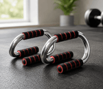 Push-up bars with black and red handles on a dark surface, likely in a home gym setting.