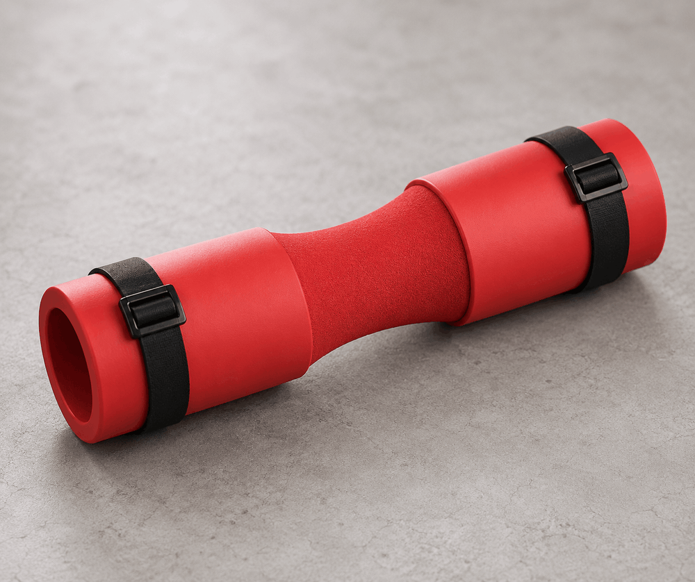 Red exercise mat with black straps on a gray surface