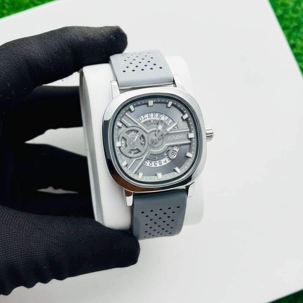 Silver watch with a black strap on a white surface At Aezoon