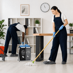 Two cleaning professionals in a modern office cleaning the floor.