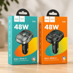 Two hoco car BT FM transmitter packages, one blue and one orange, on a wooden surface.