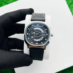 Watch with a black strap on a white surface At Aezoon