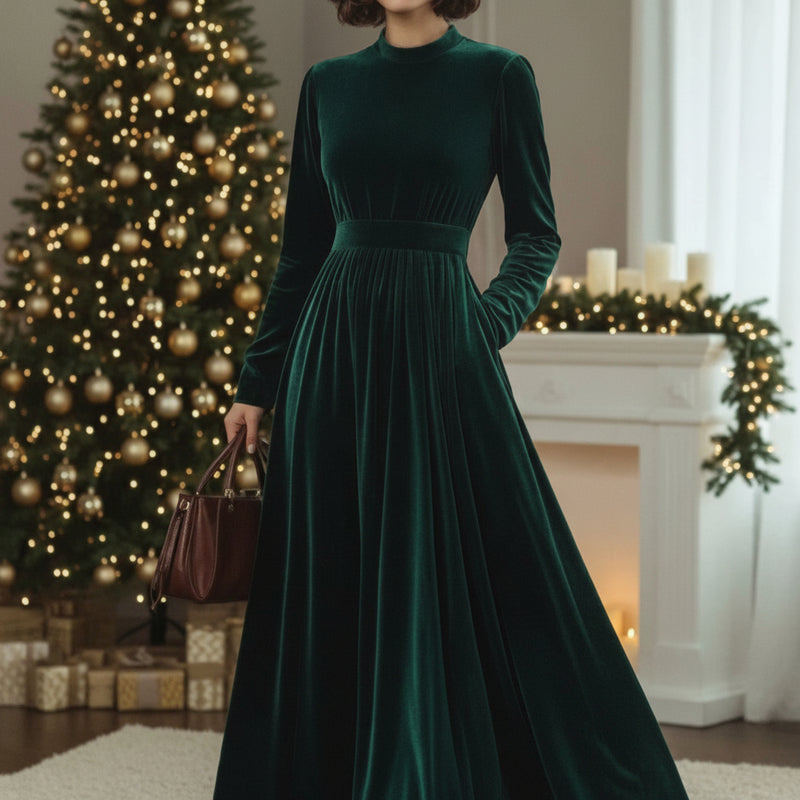 Woman in a green velvet dress standing in front of a decorated Christmas tree and fireplace. At Aezoon